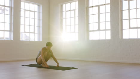 healthy yoga woman stretching flexible body enjoying fitness lifestyle practicing poses in workout studio training on exercise mat at sunrise