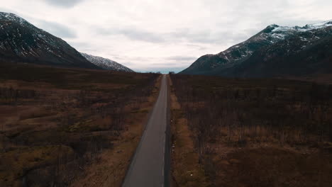 road along hostile landscape on kvaloya, northern norway, drone view