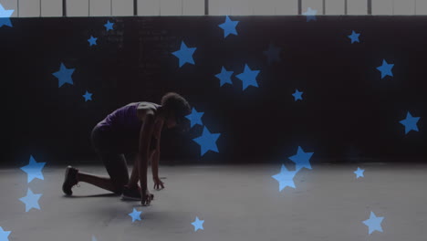 múltiples estrellas azules flotando contra una mujer afroamericana en posición de inicio lista para correr
