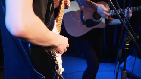 concert rock band performing on stage with two electric guitars singers. music video punk, heavy metal or rock group. slow motion instrument playing band of two men