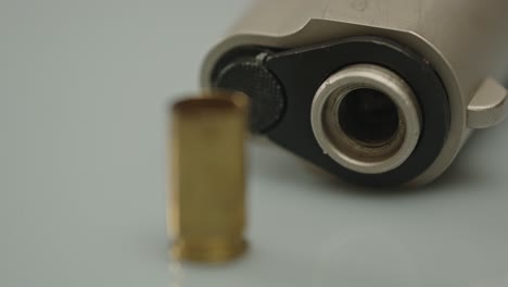 beautiful macro focus rack from pistol barrel to empty shell casing