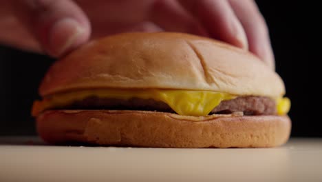 static shot cheese burger being placed in display ready to eat mc donald's style