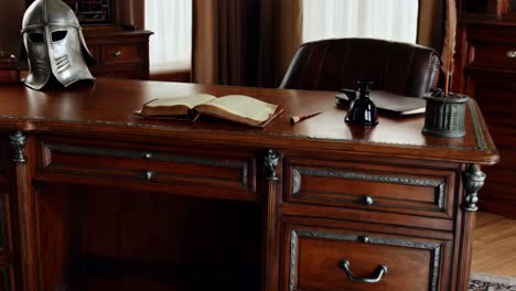 antique wooden desk with medieval helmet and open book