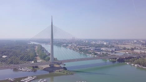 Slow-4k-aerial-shot-of-port-and-Ada-bridge-in-Belgrade,-summer-day-Serbia