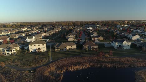 Aerial-tracking-shot-of-a-quiet-Midwestern-neighborhood-at-sunrise
