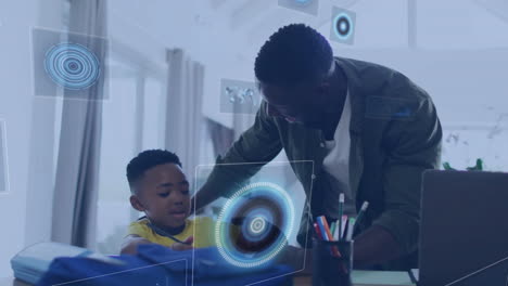 animation of data processing over happy african american father and son talking at home
