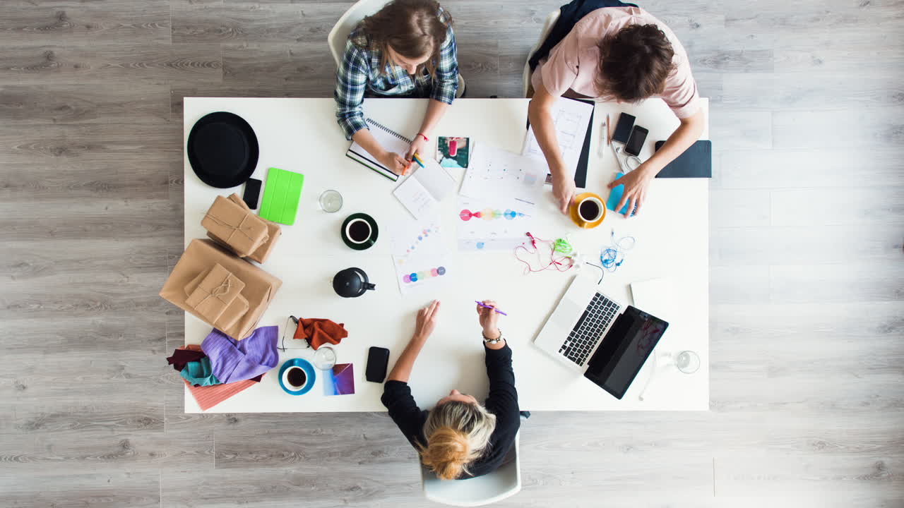 Mixed race group of people aerial viewtimelapse hipster office small business start up company planning creative meeting