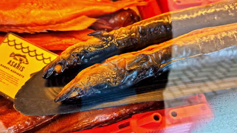 close-up of shiny smoked fish on trays at the engure zvejnieksvētki fishing festival, latvia