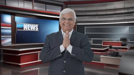 Happy-Indian-senior-journalist-doing-Namaste-and-greeting