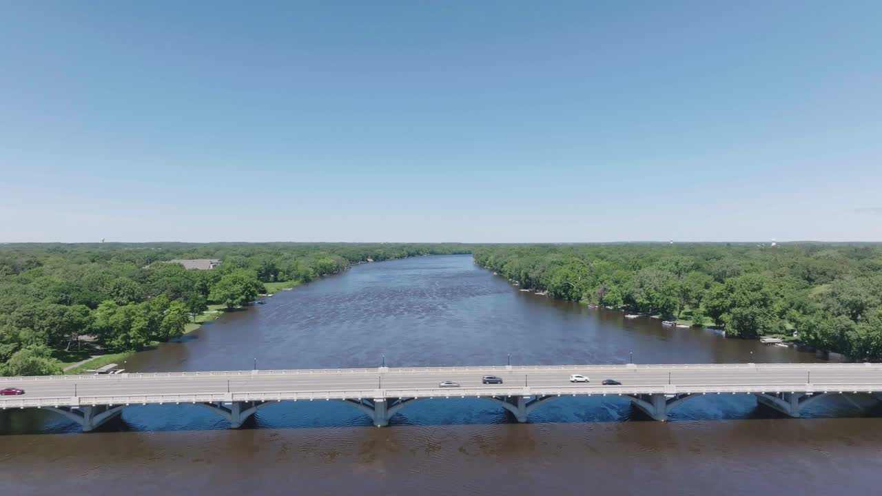 Aerial shot of a busy bridge over river in USA during office hours.