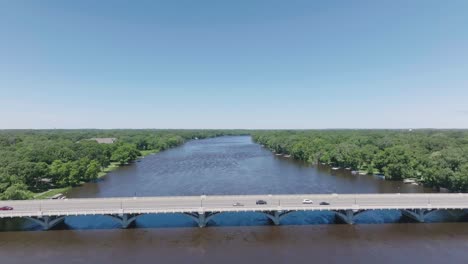 aerial shot of a busy bridge over river in usa during office hours.