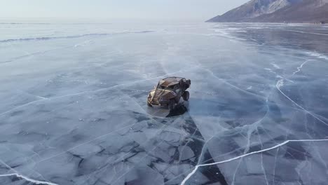 racing car drifting at lake baikal in siberia at daytime drone aerial veiw