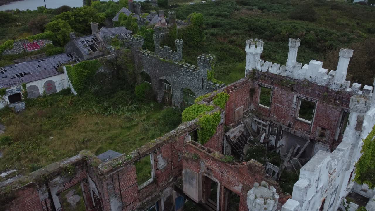 Soldiers point house aerial view over abandoned weathered ruins overgrown Victorian castle mansion