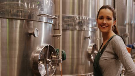 Female-worker-examining-in-factory