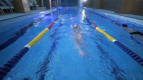 sporty young woman swimming in pool