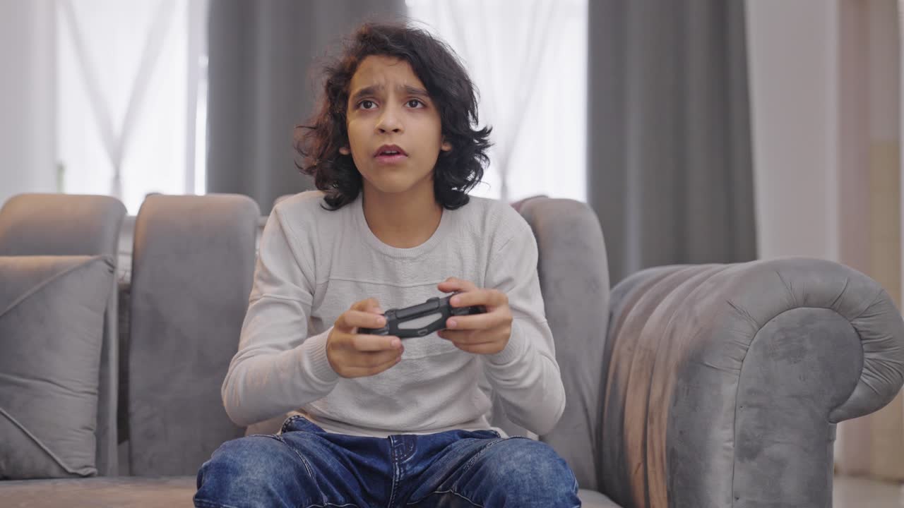 Indian kid boy playing video games