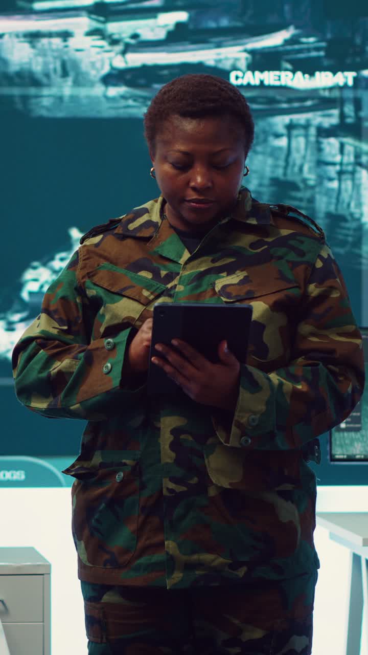 African American Woman Soldier Using Tablet in Control Room