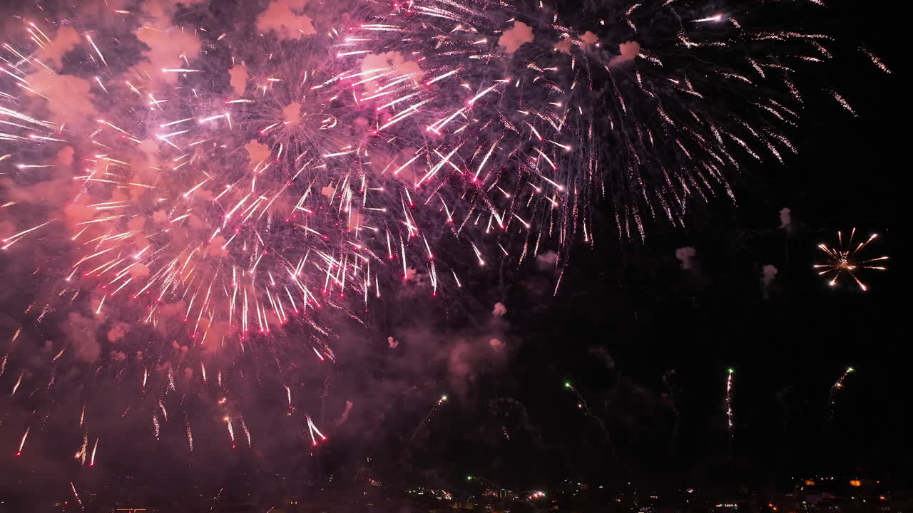 Aerial tilt reveal of fireworks and the Praça do Comércio, New Year in Lisbon