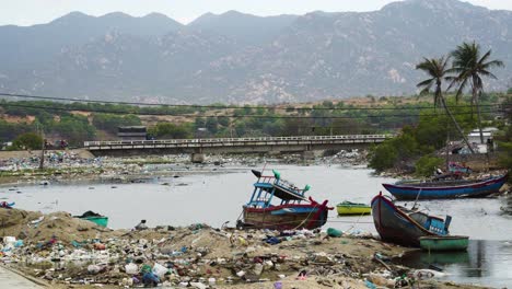 a truck driving over a bridge near lake filled with trash, in son hai