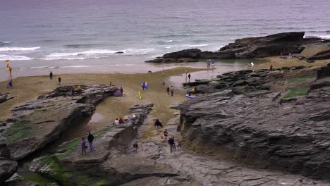 Summer evening in a rocky bay. Holidaymakers are packing away as tide is coming.Rocky mountain is in sight. Ocean waters are blue with a pink hue. Footage in HD