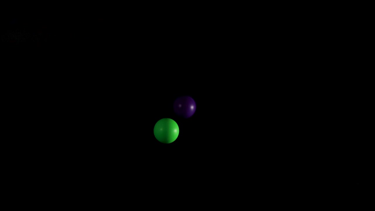 Green and purple balls bouncing in darkness