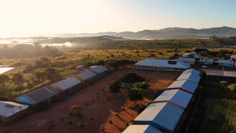 solar panels on roofs in dzaleka refugee camp, aerial establishing shot