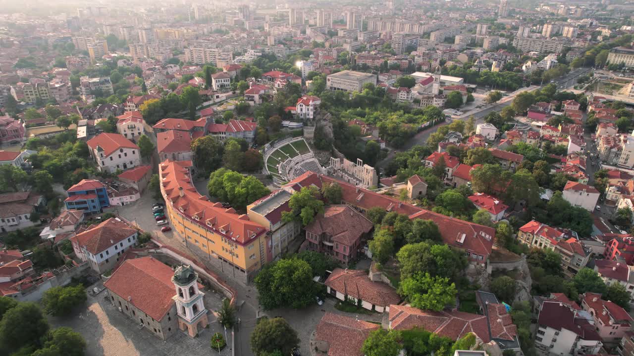 Aerial drone shot of Plovdiv Old town, Bulgaria [landmarks: Roman theatre of Philippopolis, Djumaya Mosque, Clock Tower Часовникова кула