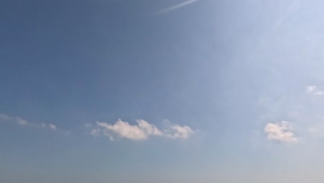 calm sea waves under a sunny sky with clouds