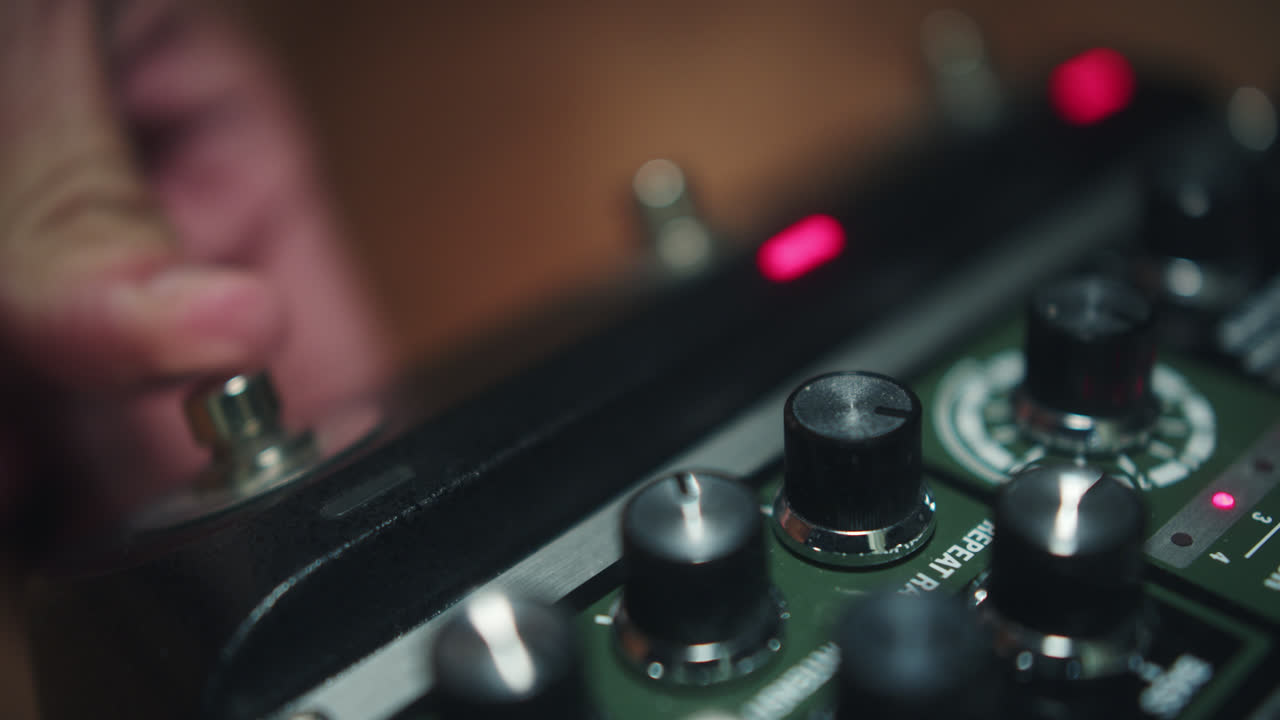 Close-up of a Person's Hand Pressing a Button on a Guitar Effects Pedal