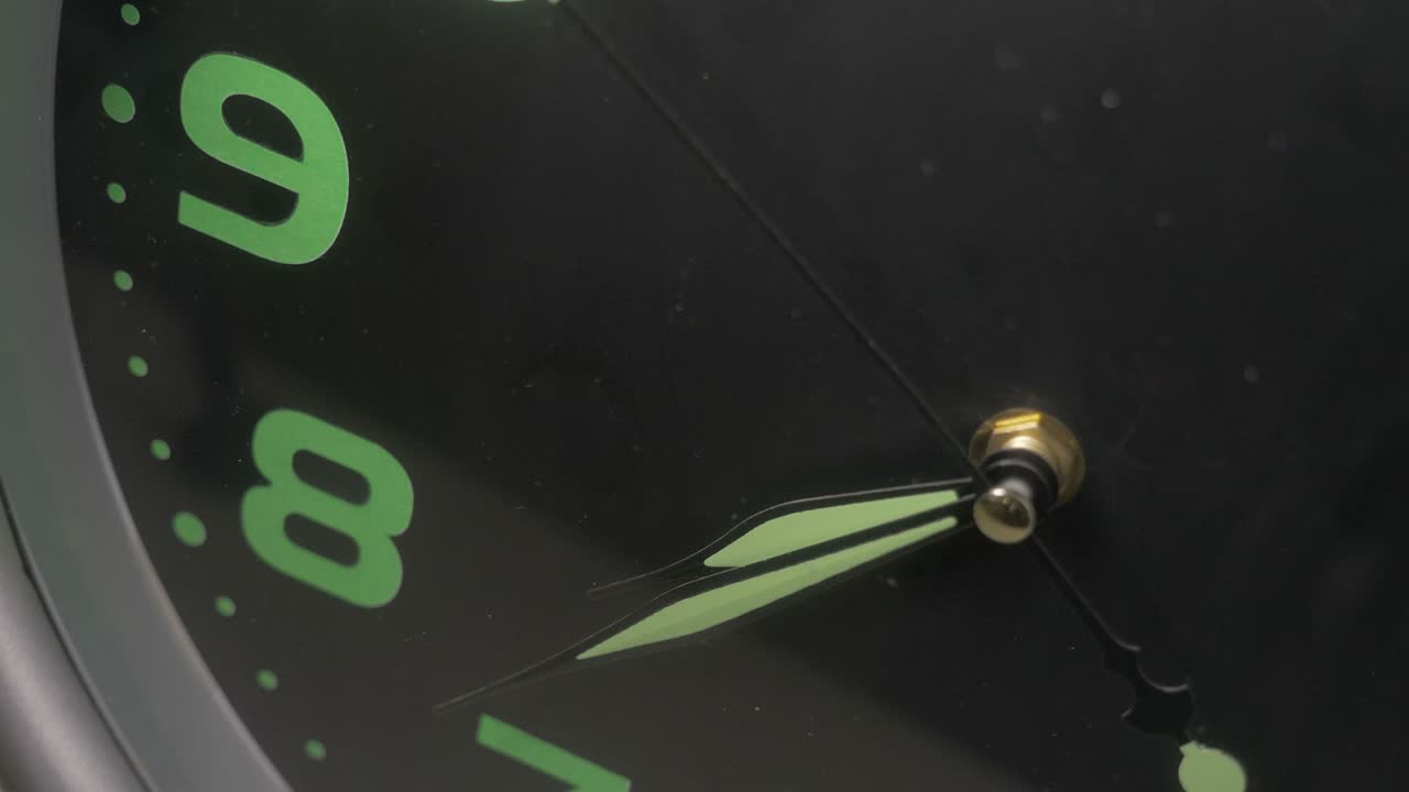close up on reverse image of wall clock - clock hands turning