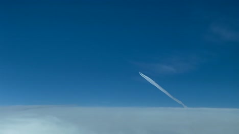 heavy jet airplane crossing in a blue sky with some clouds