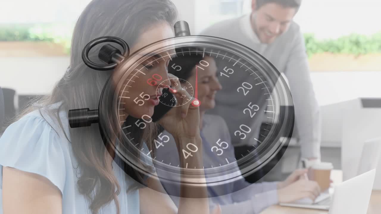 Business team working on laptops while stopwatch overlay ticking, woman calling, man handing coffee