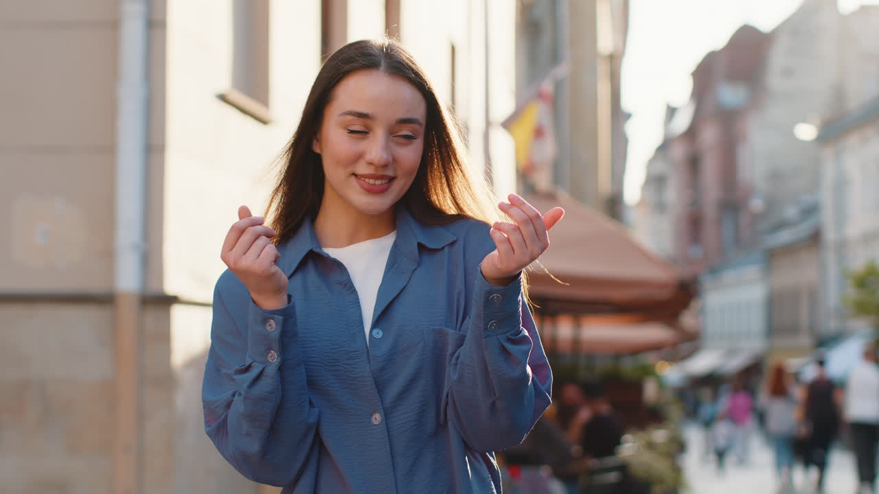 Cheerful rich woman showing wasting throwing money win lottery share celebrate in city street