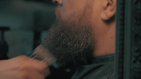 woman barber trimming beard