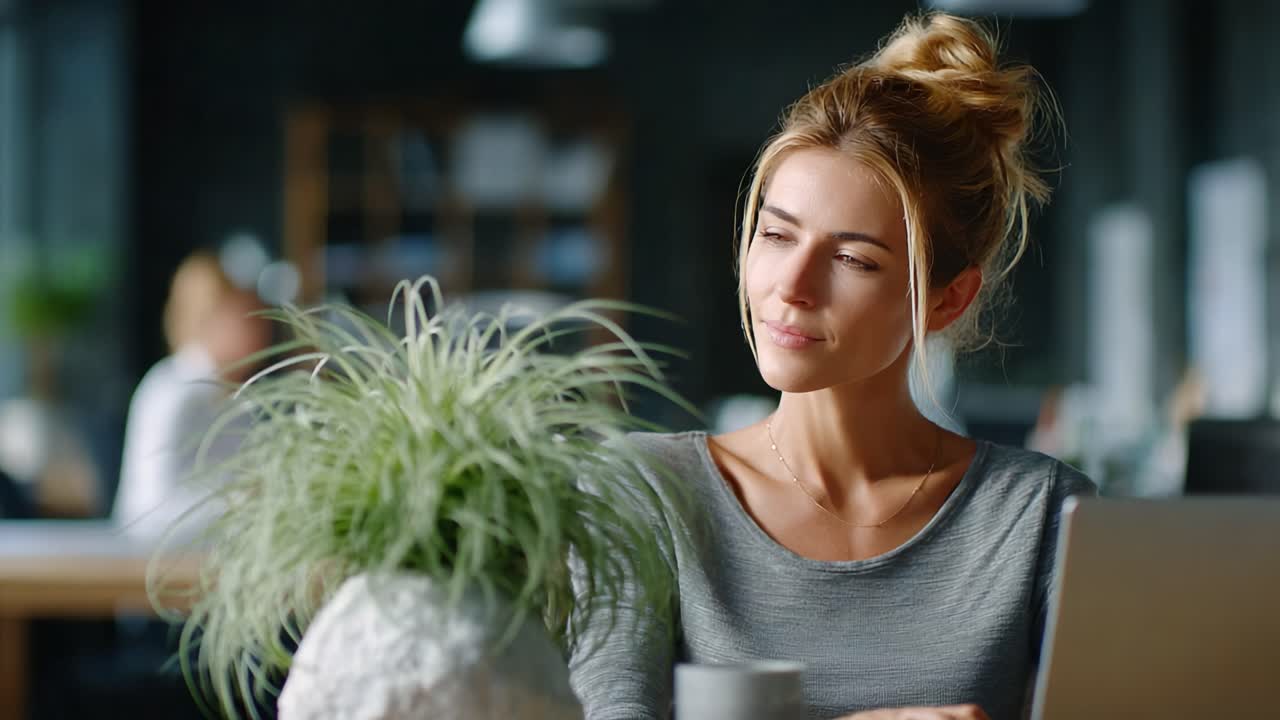 A thoughtful woman contemplating her surroundings amidst a serene workspace adorned with greenery, blending productivity and tranquility in her daily environment