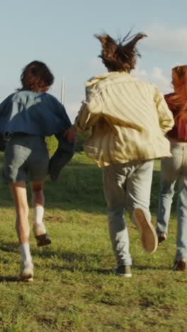 couple and friends running in a park