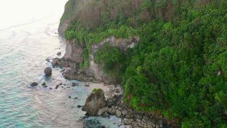 aerial-of-rocky-coastline-beach-in-uluwatu-Bali-Indonesiaat-sunset