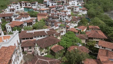 aerial-drone-shot-tropical-beach-and-hill-settlements