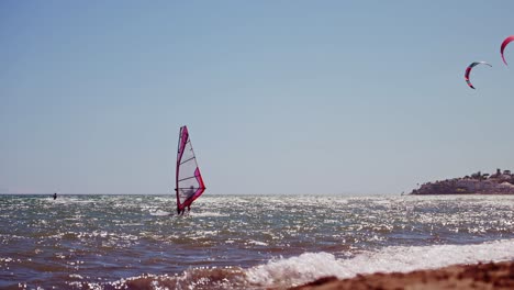 windsurfer in slow motion as seen from the beach