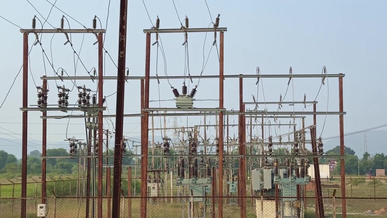 Tilt up shot of a electricity power station in India, Electrical substation with various transformers and Ceramic or Porcelain Post Insulator are being used