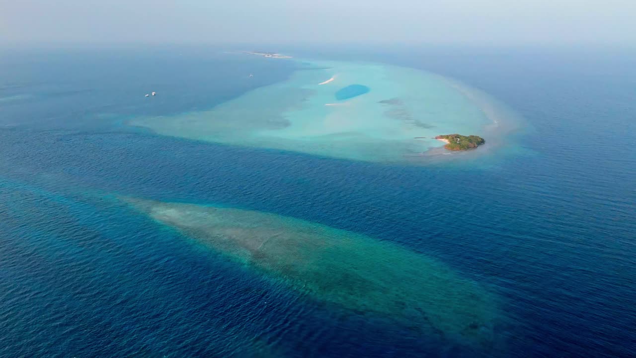 A stunning aerial drone view captures the pristine Rasdhoo Sandbanks surrounded by crystal-clear turquoise waters in the Maldives.