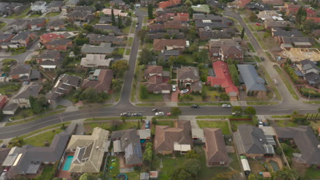 aerial view tracking black suv driving toward suburban destination