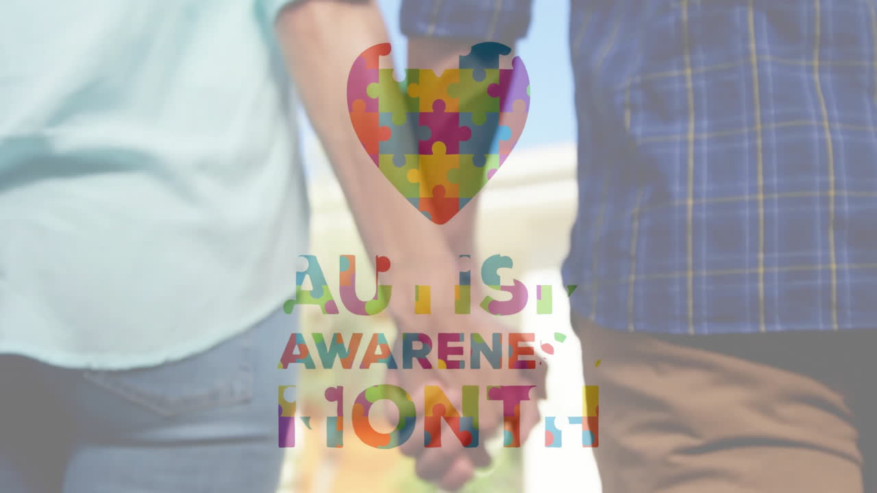 Holding hands, two people with Autism Awareness Month animation and puzzle heart