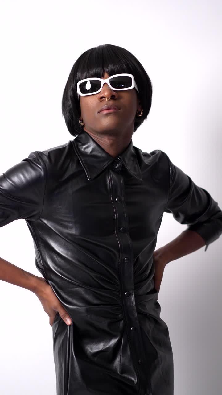 Person wearing sunglasses and a leather shirt