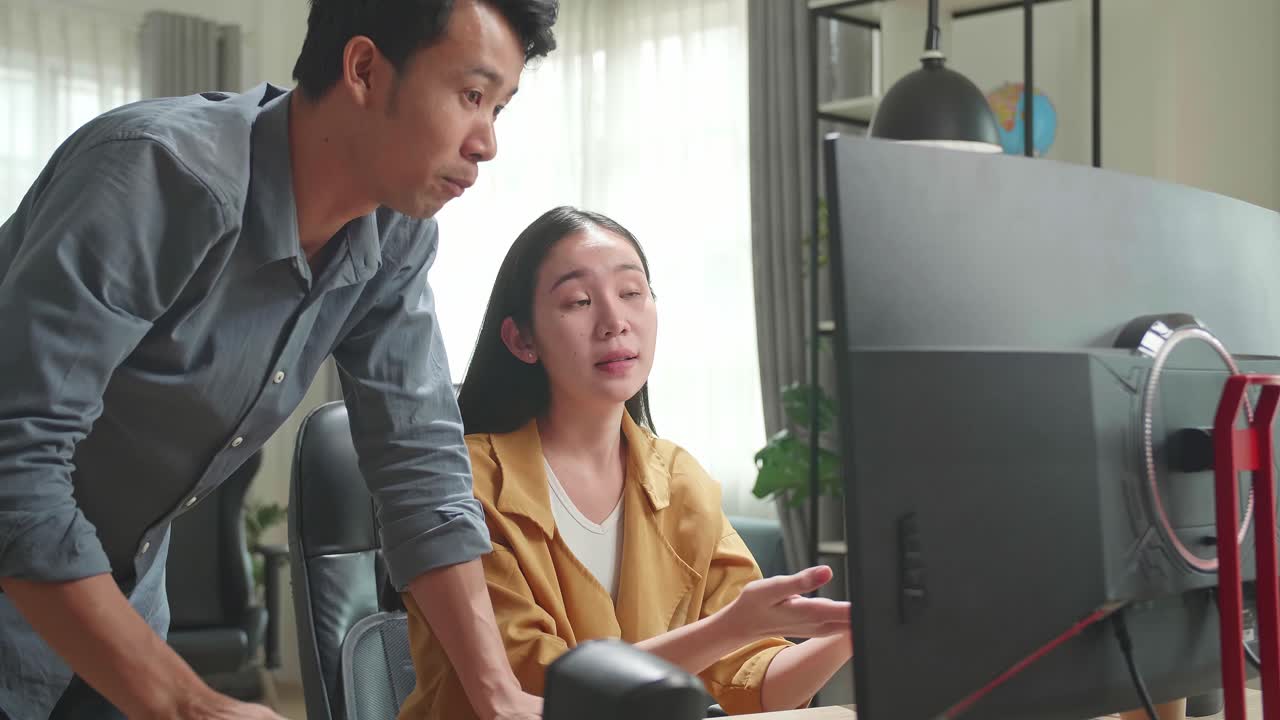 Asian Female Arguing With Male While Work On Computer In The Office
