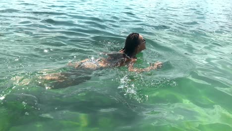 slim young girl swim in the sea