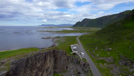 low aerial forwarding shot of a tourist enjoying the view at the bukkekjerka rest area away from crowds