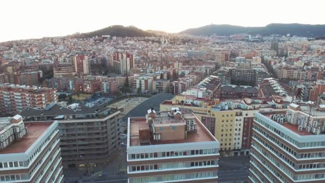 Aerial-view-of-three-buildings-in-a-big-city-with-people-on-the-rooftop