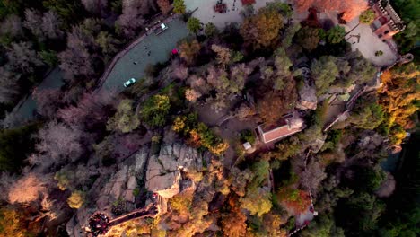 aerial top down lowering over benjamín vicuña mackenna tomb at santa lucial hill covered in autumnal trees, santiago, chile