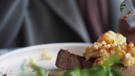 scrambled eggs on toast with a side of greens